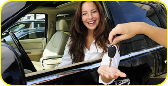Happy Woman Sitting In a Car Being Handed Car Keys